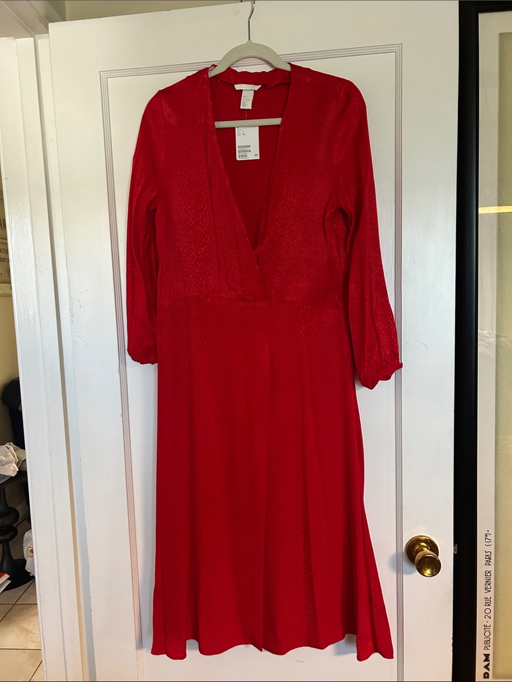 H&M red dress features a subtle snakeskin print and a faux wrap design.
